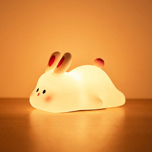 Bunny Night Lamp glowing warm on a bedside table
