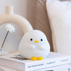 Duck Night Lamp glowing warm on a bedside table