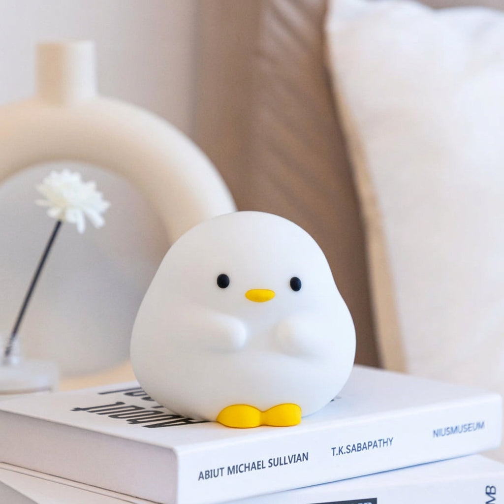 Duck Night Lamp glowing warm on a bedside table